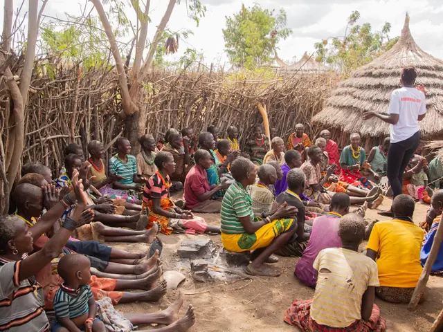 A rural community gathered in a circle for a dialogue and engagement session